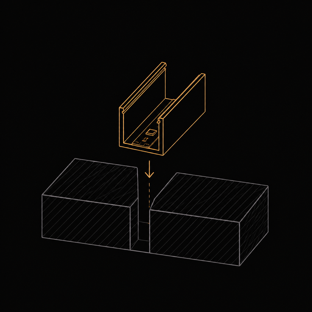 Line drawing of an aluminium channel lowering into the gap between two pavers